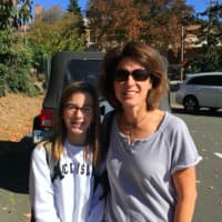 <p>Karen Secrist with her daughter, a student at Tomlinson Middle School in Fairfield. The students were dismissed early after a lockdown related to 911 threats disrupted the school day.</p>