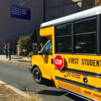 <p>A bus arrives to take students home from Fairfield Ludlowe High School after a districtwide school lockdown in Fairfield after reports of threats.</p>