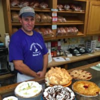 <p>Bill Hunniford, co-owner of the American Pie Co. in Sherman, stands behind some of the restaurant&#x27;s pies.</p>