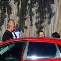 <p>Stamford Police Chief Jon Fontneay, at left in black shirt, talks with Maxine Gooden&#x27;s daughter, Danielle, who is obscured by a car. Gooden was shot to death after 10 p.m in Stamford in front of family and friends including Danielle.</p>