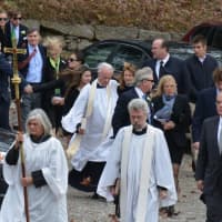 <p>A large procession leaves St. James Episcopal Church in North Salem following the funeral of Lois Colley. The procession is from the church to a nearby cemetery.</p>
