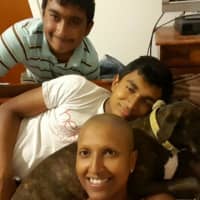 <p>Shivonie Deokaran with her two sons and beloved dog, Gia.</p>