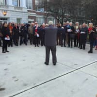 <p>Serge Gabriel leads the singing of the French national anthem, La Marseillaise during a ceremony Friday morning in front of Greenwich Town Hall to remember those killed in the Paris terrorist attacks last week.</p>