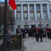 <p>Serge Gabriel raises the French flag in front of Greenwich Town Hall in memory of those murdered in last week&#x27;s terror attacks in Paris.</p>
