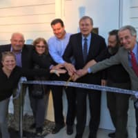 <p>Stamford Mayor David Martin cuts the ribbon at the official opening of the expansion to the Dressing Room Theatre Friday.The six-month $800,000 city project adds an additional 2,500 square space to the theatre. </p>