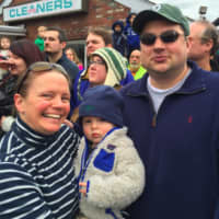 <p>Finley Kappler, center, watches his first UBS Parade Spectacular on Sunday, along with his parents Libby and Christopher.</p>