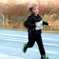 <p>A young boy runs in Sunday&#x27;s race at the Danbury Fair Mall. </p>