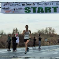 <p>Mary Zengo of Wilton strides across the finish line to win the women&#x27;s division of the Mima&#x27;s Meatball Mile for MSA Sunday in Danbury. </p>
