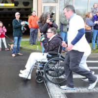 <p>JP Henson of Ridgefield, who has MSA, gets assistance from some runners at the start of the race.</p>