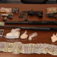 <p>Weapons, cash and drugs gathered in the investigation that saw 30 people arrested for selling heroin and cocaine.</p>