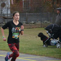 <p>A runner heads towards the finish line at the 11th annual Bedford Turkey Trot.</p>