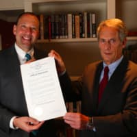 <p>Attorneys Steven Frederick (left) and Marshall Goldberg, pose with the official declaration of Nov. 9 as “Wofsey, Rosen, Kweskin &amp; Kuriansky Day in the State of Connecticut.”</p>