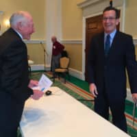 <p>Gov. Dannel Malloy shares a laugh with Bob Wylie from the Retired Men&#x27;s Association of Greenwich after speaking to the group Wednesday.</p>