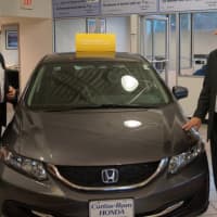 <p>State Sen. Kevin Kelly checks out a new car during a tour at Curtiss Ryan Honda in Shelton.</p>