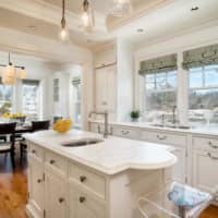 <p>A stunning custom kitchen includes Carrara marble counters.</p>