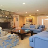 <p>A massive stone fireplace is the centerpiece of the living room. </p>