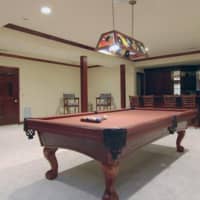 <p>A pool table and wet bar make for a perfect place to entertain guests.</p>