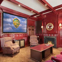 <p>The theater room has a huge screen for watching events.</p>