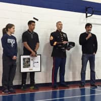 <p>Donn Cabral, Marine Staff Sgt. Jason Caldwell, and SI Managing Editor, Chris Stone present the award to DeBalsi.</p>