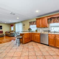 <p>The kitchen connects with a newly installed living space, creating an open floor plan on the first floor.</p>