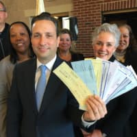 <p>Senate Majority Leader Bob Duff (D-Norwalk) holds up checks totaling $17,150 for eight local nonprofits at the Norwalk Fire Department Station #2 on Connecticut Avenue. The donations came as a result of his annual holiday party.</p>