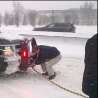 <p>Gov. Andrew Cuomo assists a stranded motorist on the Cross Island Parkway in Nassau County early Saturday afternoon before the travel ban went into effect.</p>