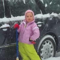 <p>Ella Starpoli helping to dig out the family car during the storm.</p>