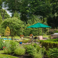 <p>The property at 727 Bedford Road is artistically landscaped and includes an inground pool.</p>