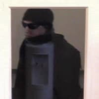 <p>The Brookfield Police Department released this photo of the bank robbery suspect. A reflection distorts the image.</p>