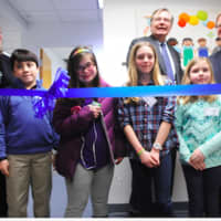 <p>Official ribbon cutters from left, front row, Wesley Elkind, Louisa Knapp, Molly and Katie Hayes, wait for Stamford Mayor David Martin to say the word as Linda Talbert, and Dennis Perry look on.</p>