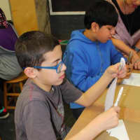 <p>Students carefully cut out their puppets.</p>