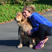 <p>McDonnell snuggles up with her dog after a run.</p>