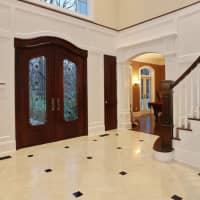 <p>A beautiful foyer greets people upon arrival into the home.</p>