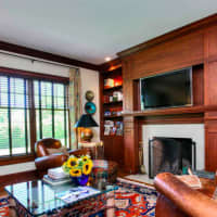 <p>The spacious family room includes a fireplace, one of two at the home.</p>