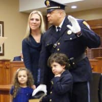<p>Ridgewood Lt. Heath James is sworn in accompanied by his wife and children.</p>