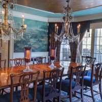 <p>The dining room has magnificent chandeliers and lots of natural light.</p>