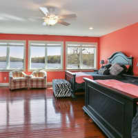 <p>The spacious bedroom has magnificent lake views.</p>