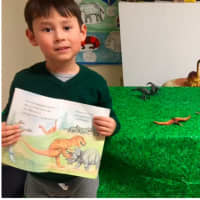 <p>Tommy Mullen has fun with dinosaurs at the Weinberg Nature Center in Scarsdale.</p>