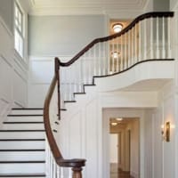 <p>A beautiful staircase greets people upon stepping into the home.</p>
