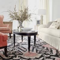 <p>Here, we built a living room around the rose tones in our Turkish-knotted ikat rug. The space gets its splash and sparkle from bright, saturated coral fabrics and lots of metallic touches.</p>