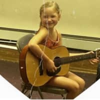 <p>Mellie Stasko, 8, and her guitar.</p>