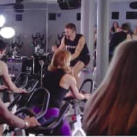 <p>Adam Keller, 29, an indoor cycling instructor at JoyRide Cycling Studio, organized a top-secret choreographed flash mob at the Westport studio, to propose to his boyfriend of one year, Jared Marinelli, 31, pictured facing riders.</p>