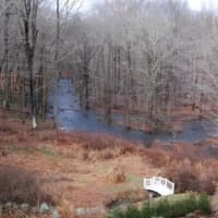 <p>The property abuts a tributary of the Saugatuck River and borders acres of woodlands in bucolic Weston.</p>