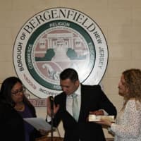 <p>Kevin Helder is sworn in as wife, Jennifer, looks on.</p>