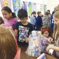 <p>Students at East Elementary School, in New Canaan, packed items for Fill the Blanks bags, after having gathered food in a food drive.</p>