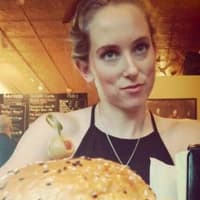 <p>A customer practices self-control and allows someone take a picture of her Black Rebel burger.</p>