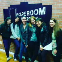 <p>Escape Room NJ team members smile because they made it out.</p>