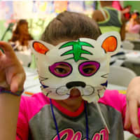 <p>Members of the Boys and Girls Club enjoy their time at the event making tiger masks.</p>