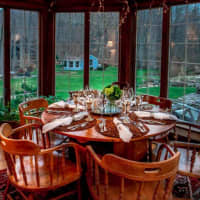 <p>The dining room has long windows and lots of natural light.</p>