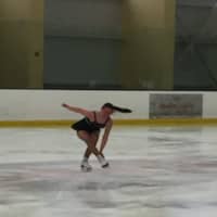 <p>Laurel Ridge club member Julia Hinton of Oxford finishes her sit spin as she completes and passes her freestyle skating test.</p>